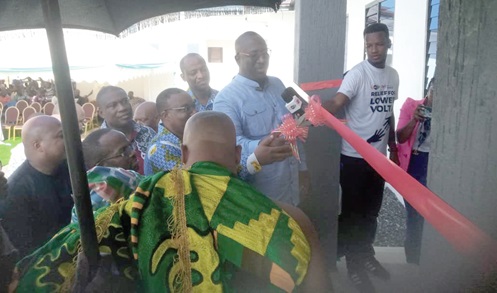  The front view of the Mepe Health Centre. INSET: Samuel Attah-Mensah (arrowed) being assisted by Joshua Mortoti (partly covered),  President, the Ghana Chamber of Mines, and Togbe Korsi Nego VI (back to camera) to cut the tape. Pictures: Benjamin Xornam Glover