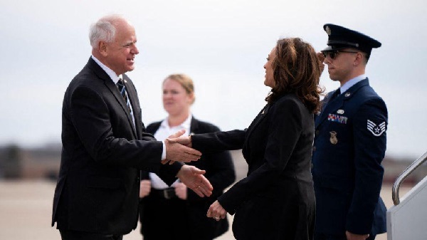 Kamala Harris in a warm handshake with Tim Walz Kamala Harris in a warm handshake with Tim Walz
