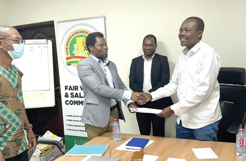 Ben Arthur (right), CEO, Fair Wages and Salaries Commission, and Peter Akudugi Ayamba, President of the Physician Assistants Association of Ghana, exchanging documents after signing the agreement Ben Arthur (right), CEO, Fair Wages and Salaries Commission, and Peter Akudugi Ayamba, President of the Physician Assistants Association of Ghana, exchanging documents after signing the agreement
