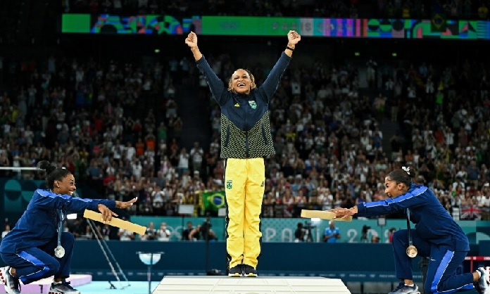 As Andrade was presented to accept her gold medal in the first Olympic gymnastics podium with three black medallists, both Biles and Chiles turned to face Andrade and they bowed to the new champion As Andrade was presented to accept her gold medal in the first Olympic gymnastics podium with three black medallists, both Biles and Chiles turned to face Andrade and they bowed to the new champion