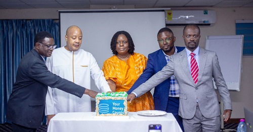 The YMC Ghana team cutting a a cake at the launch The YMC Ghana team cutting a a cake at the launch
