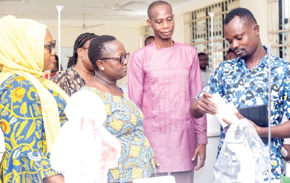 Fairuza Safian (left), Director, CAMFED Ghana, with some dignitaries inspecting the equipment at the Asuansi Technical Institute science laboratory
