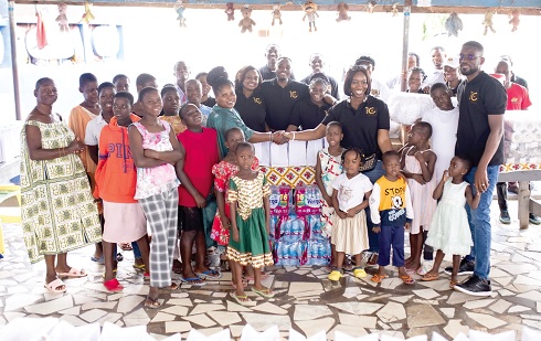 Maame Ama Asantewaa Adjem (3rd from right) with Randy Attuquaye Clottey (right), leading the Golden Bean Hotel team, to hand over the items