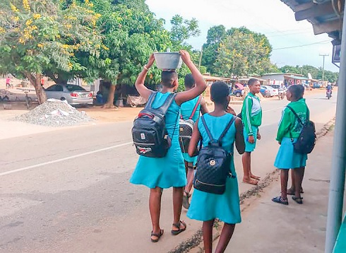 Students walking along the main street to their school