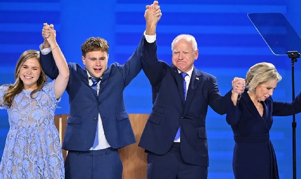 Mr Walz (third from left) praised his family onstage, and spoke of how he and his wife went through fertility treatments Mr Walz (third from left) praised his family onstage, and spoke of how he and his wife went through fertility treatments