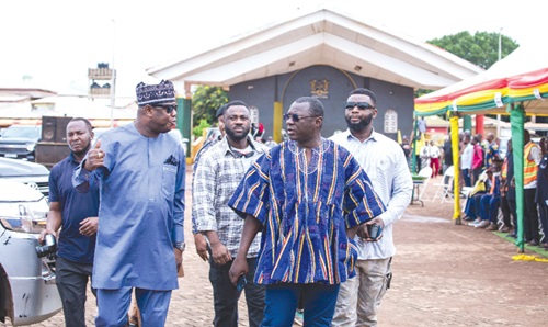 Dr Mohammed Amin Adam (right), Finance Minister and Member of Parliament for Karaga, interacting with Farouk Mahama (left), MP for Yendi, after the presentation of the equipment