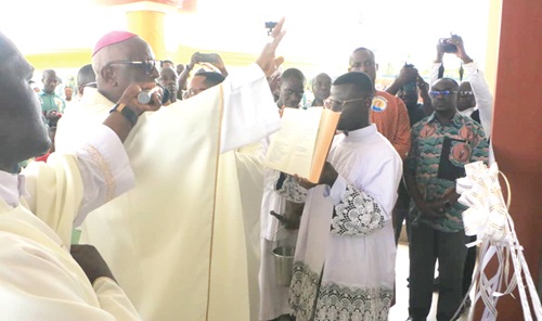 Most Rev. Joseph Afrifah Agyekum (hand raised), Bishop of Koforidua Diocese, Catholic Church, dedicating the new facility. INSET: The new medical college Most Rev. Joseph Afrifah Agyekum (hand raised), Bishop of Koforidua Diocese, Catholic Church, dedicating the new facility. INSET: The new medical college