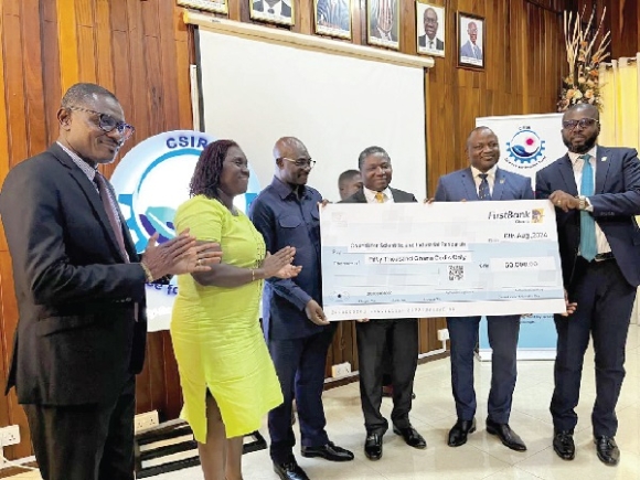 • Semiu Lamidi (2nd from right), Executive Director, FirstBank Ghana, Prof. Paul Bosu (3rd from right), Director General, CSIR, and some officials of FirstBank and Council with the dummy cheque FirstBank Ghana supports CSIR to drive innovative business solutions