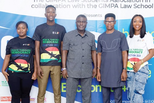 Bossman Asare (middle), Deputy EC Chair in charge of Corporate Services, Dr Benjamin Agordzo ACP (rtd) (2nd from right) and  some GIMPA Law School students 