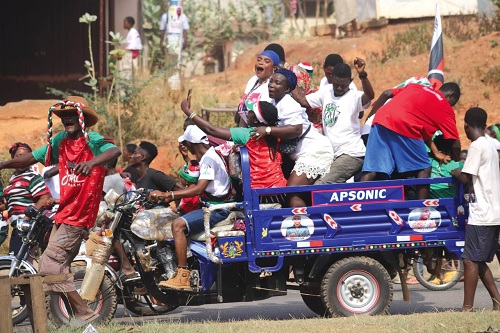 Some NDC supporters in the bucket of a tricycle popularly known as Aboboyaa in Kumasi, jubilating
