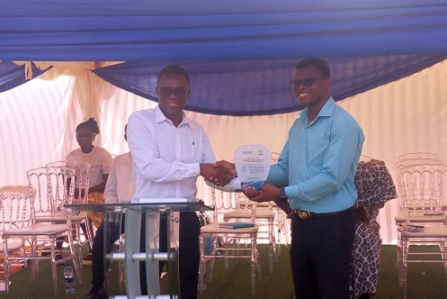 Dr Afake Hornametor (left), Head of the National Eye Care Unit, handing an award shield to Dr Felix Dabaa, Awutu Senya District Director of Health