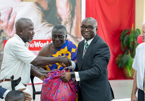 A beneficiary (left) receiving a pack of essential food items in Takoradi