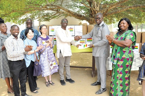 Frederick Birikorang (3rd from right), Director of Partnerships and Affiliations, GES, presenting a book to Francis Agbemadi (2nd from right) while Isabella Ayimey (right), North Tongu District Director of Education, and officials of JICA look on Frederick Birikorang (3rd from right), Director of Partnerships and Affiliations, GES, presenting a book to Francis Agbemadi (2nd from right) while Isabella Ayimey (right), North Tongu District Director of Education, and officials of JICA look on