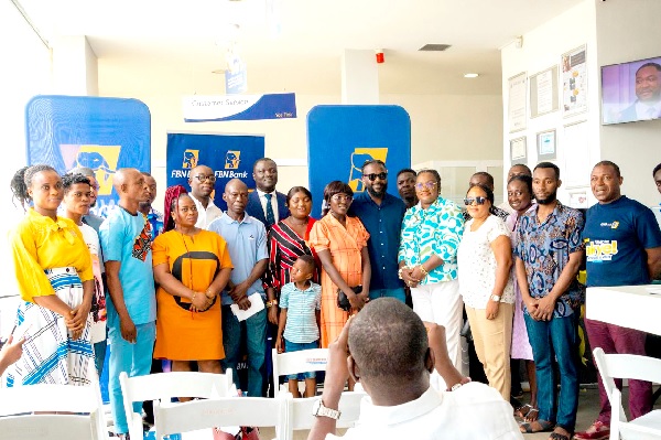• Victor Yaw Asante (in suit), Managing Director of FBN Bank, with Samini, (6th from right ), ambassador of the promotion, and winners of the promotion FBN Bank rewards customers with home appliances