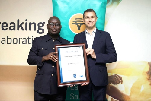 Warren Adams (right), First National Bank CEO, receives the  certification from Nii Abeka Gyeshie, ISO27001 Certification Auditor