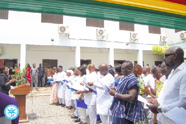 Nancy Teiko Searyoh (left), a Magistrate, swearing in members of the Ablekuma North Municipal Assembly.