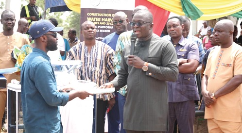 Dr Bryan Acheampong (right), Minister of Food and Agriculture, presenting the project documents to a representative of the contractors Dr Bryan Acheampong (right), Minister of Food and Agriculture, presenting the project documents to a representative of the contractors