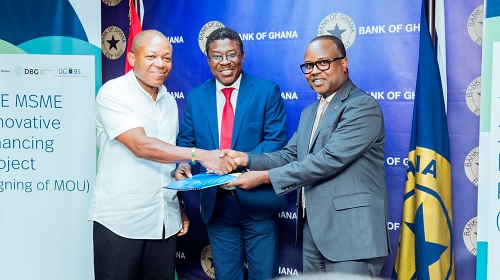 Dr Maxwell Opoku-Afari (right), 2nd Deputy Governor, BoG, Prof. Justice Bawole (middle), Dean, UGBS, and Kwamina Duker (left), CEO of DBG, exchanging the MoU Dr Maxwell Opoku-Afari (right), 2nd Deputy Governor, BoG, Prof. Justice Bawole (middle), Dean, UGBS, and Kwamina Duker (left), CEO of DBG, exchanging the MoU