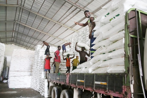 Workers busily loading some of the inputs into trucks for onward distribution Workers busily loading some of the inputs into trucks for onward distribution