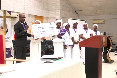 Cynthia Serwaa Dogbe (5th from right), Missionary Supervisor of the Western West Africa Episcopal District of the AME Zion Church, presenting the dummy cheque to Rt Rev. Dr Hilliard Dogbe, Presiding Bishop of the African Methodist Episcopal Zion Church Cynthia Serwaa Dogbe (5th from right), Missionary Supervisor of the Western West Africa Episcopal District of the AME Zion Church, presenting the dummy cheque to Rt Rev. Dr Hilliard Dogbe, Presiding Bishop of the African Methodist Episcopal Zion Church