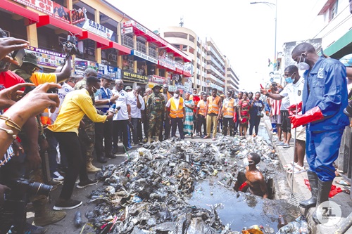 Volunteers clearing debris from gutters in the Central Business District of Accra