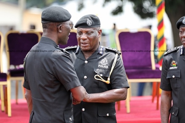 IGP Dampare (left) in a handshake with COP Yohuno IGP Dampare (left) in a handshake with COP Yohuno