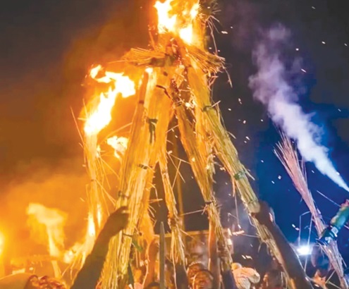 As part of the fire festival, celebrants light the thatch after which they go on a procession through the principal streets of the community As part of the fire festival, celebrants light the thatch after which they go on a procession through the principal streets of the community