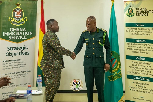 Armwrestling coach Nii Otoo Larkyne with the Comptroller-General Armwrestlers promoted by Ghana Immigration Service after excelling at Africa Games