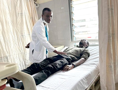 Dr Amoah examining a patient on one of the  wards at the Korle Bu Teaching Hospital Dr Amoah examining a patient on one of the  wards at the Korle Bu Teaching Hospital