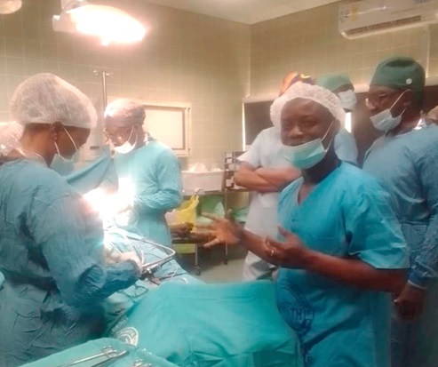 Dr Amoah (hands raised) with a team of other specialists in the theatre Dr Amoah (hands raised) with a team of other specialists in the theatre