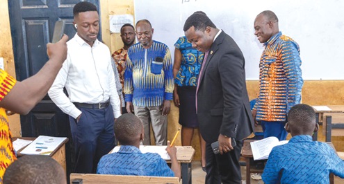 Rev. John Ntim Fordjour (in suit), Deputy Minister of Education, at the National Standardised Test Centre at the Flagstaff House Basic School