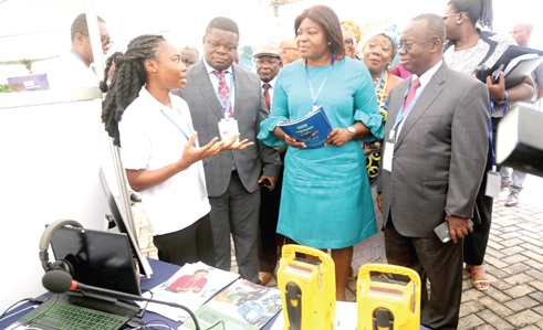 Naomi Nsiah (left), a volunteer, explaining how some of the products work to Ophelia Mensah Hayford (2nd from right), Minister of Environment, Science, Technology and Innovation, during an exhibition. With them are Prof. Peter Quartey (2nd from left), Director, Institute of Statistical, Social and Economic Research, and Dr David Ameyaw (right), CEO, International Centre for Evaluation and Development. Picture: SAMUEL TEI ADANO Naomi Nsiah (left), a volunteer, explaining how some of the products work to Ophelia Mensah Hayford (2nd from right), Minister of Environment, Science, Technology and Innovation, during an exhibition. With them are Prof. Peter Quartey (2nd from left), Director, Institute of Statistical, Social and Economic Research, and Dr David Ameyaw (right), CEO, International Centre for Evaluation and Development. Picture: SAMUEL TEI ADANO