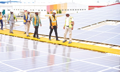 Herbert Krapa (2nd from right) being led to inspect the rooftop solar panels after the inauguration Herbert Krapa (2nd from right) being led to inspect the rooftop solar panels after the inauguration