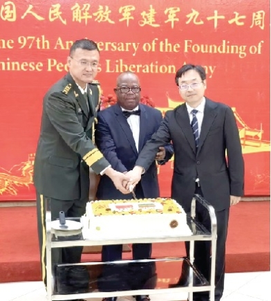 From left: Col. Song Jun, Defence Attache, Major General Joseph Aduko Aphour from GAF, and LI Yang, the Chargé d'Affaires of Chinese Embassy/Ministerial Counsellor, cutting the anniversary cake From left: Col. Song Jun, Defence Attache, Major General Joseph Aduko Aphour from GAF, and LI Yang, the Chargé d'Affaires of Chinese Embassy/Ministerial Counsellor, cutting the anniversary cake