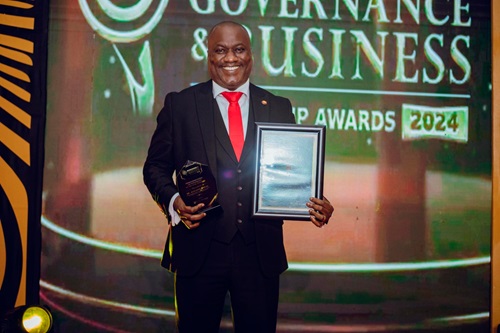 Augustine Appiah, Head of HR and Administration of BOST Company, displaying the award Augustine Appiah, Head of HR and Administration of BOST Company, displaying the award