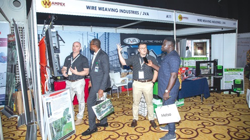 Ryan Du Toit (2nd from right), the Brands and Digital Marketing Manager of JVA South Africa, explaining the operations of the company to Maclean Kwofi, a Daily Graphic Reporter, at the exhibition stand