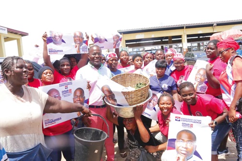 Charles Bissue (arrowed) with some of the market women