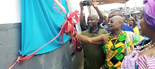 Barima Osafo Ntifo, (2nd from right), Abusuapanyin of Amanorkrom, being assisted by Ebenezer Yeboah Mireku, Secretary to the Okuapemman Fekuw of USA, to cut the ribbon to inaugurate the project Barima Osafo Ntifo, (2nd from right), Abusuapanyin of Amanorkrom, being assisted by Ebenezer Yeboah Mireku, Secretary to the Okuapemman Fekuw of USA, to cut the ribbon to inaugurate the project