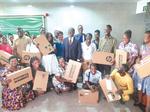  Mr Afenyo-Markin (arrowed), the Majority Leader, with the beneficiaries of the laptops.