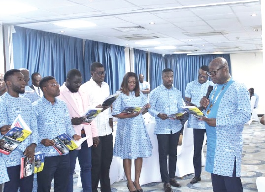 Dr Daniel Kasser Tee (right), National President of CIMG, swearing in new members of the organisation Dr Daniel Kasser Tee (right), National President of CIMG, swearing in new members of the organisation
