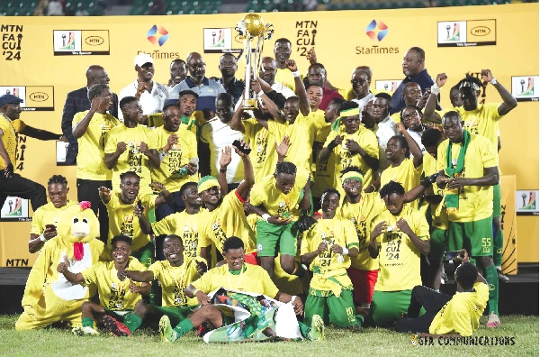 Players of Nsoatreman FC celebrating with the MTN FA Cup trophy after yesterday’s historic victory 
