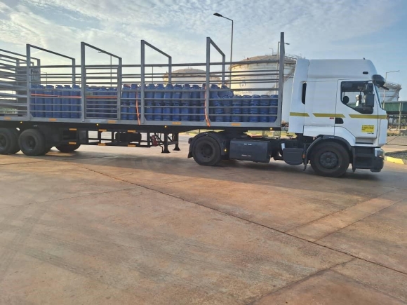 Truck with filled cylinders departs from bottling plant to Puma Gas exchange points. A Puma Gas exchange point for consumers to pick up filled cylinders.
