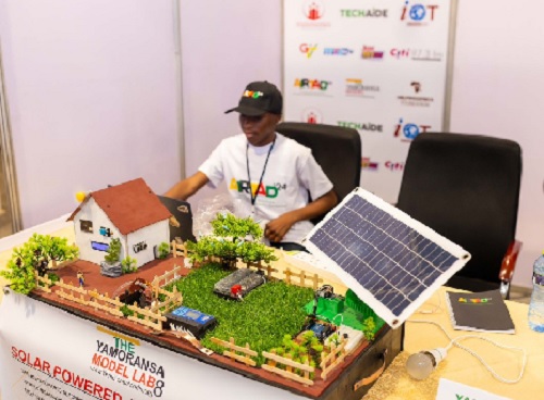A participant showcasing a model of a solar-powered innovation A participant showcasing a model of a solar-powered innovation