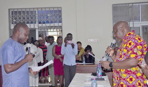 Seth Kwame Acheampong (right), Eastern Regional Minister, swearing in Douglas Paddy Amponsah, the new Atiwa West District Chief Executive Seth Kwame Acheampong (right), Eastern Regional Minister, swearing in Douglas Paddy Amponsah, the new Atiwa West District Chief Executive