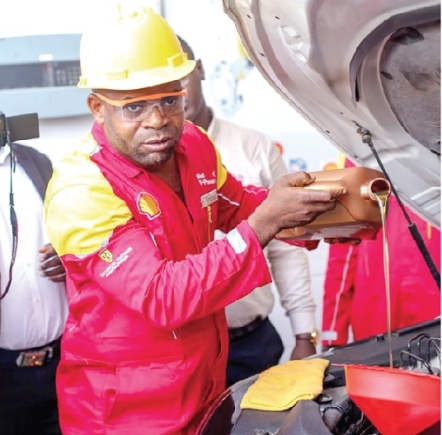 A staff at Shell demonstrating the quality of the new lubricant Vivo Energy Ghana sets new industry standards — Launches new Shell Helix Ultra lubricant