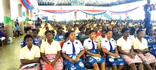 Some of the students of Krobo Girls SHS listening attentively to the speakers. INSET: Evelyn Oye Lamptey, Guest speaker, delivering her speech Some of the students of Krobo Girls SHS listening attentively to the speakers. INSET: Evelyn Oye Lamptey, Guest speaker, delivering her speech