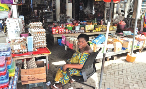 Rejoice Norvixoxo, Ho Central Market Queen, sitting in front of her shop