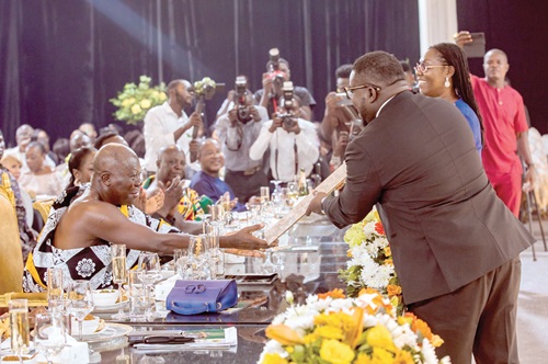 Otumfuo Osei Tutu II, being presented with one of the framed commemorative gold stamps by Bice Osei Kuffour, MD, Ghana Post Company Ltd. Otumfuo Osei Tutu II, being presented with one of the framed commemorative gold stamps by Bice Osei Kuffour, MD, Ghana Post Company Ltd.