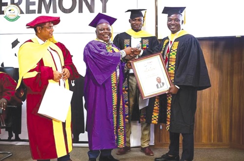 Joseph Cudjoe (2nd from left), Minister of Public Enterprises, presenting a citation to Emmanuel Gyadu (right), the valedictorian Joseph Cudjoe (2nd from left), Minister of Public Enterprises, presenting a citation to Emmanuel Gyadu (right), the valedictorian