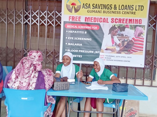 A resident (left) being screened by health professionals A resident (left) being screened by health professionals